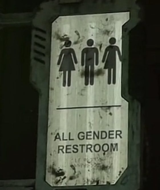 Un panneau indicatif de toilettes mixtes dans Dead Space 2.